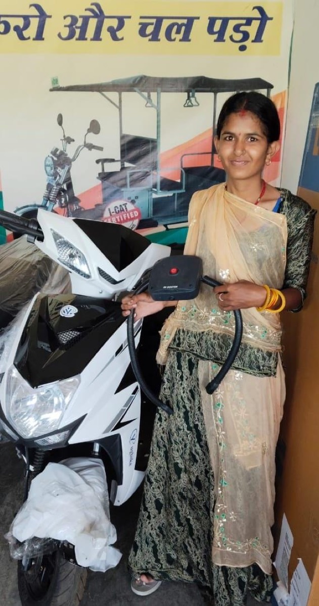 Electric scooter professional holding the EV DOCTOR battery diagnostic device