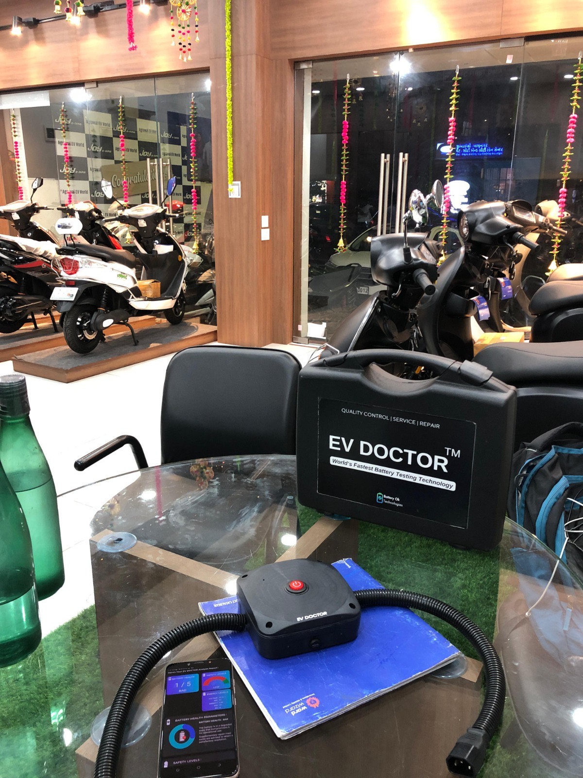 EV DOCTOR battery diagnostic kit deployed inside an electric scooter showroom